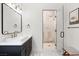 This bathroom features a vessel sink, marble countertop, black fixtures and a luxurious glass-enclosed shower at 10717 Beringer Dr, Las Vegas, NV 89144