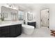 Sleek bathroom features modern fixtures, a standalone tub, and sink vanities, and walk-in shower at 10717 Beringer Dr, Las Vegas, NV 89144
