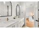 Elegant bathroom with double vanity, decorative mirrors, quartz countertop and luxurious fixtures at 10717 Beringer Dr, Las Vegas, NV 89144