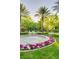 Beautiful community fountain with colorful flowers and lush landscaping provides a serene focal point at 10717 Beringer Dr, Las Vegas, NV 89144