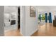 Bright hallway with hardwood floors leads to an open living area at 10717 Beringer Dr, Las Vegas, NV 89144