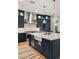Well-lit kitchen features stainless steel appliances, kitchen island with pendant lighting, and modern fixtures at 10717 Beringer Dr, Las Vegas, NV 89144
