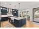 Modern kitchen with dark blue cabinets, stainless steel appliances, and a farm style sink at 10717 Beringer Dr, Las Vegas, NV 89144