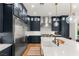 Close-up of a modern kitchen featuring dark blue cabinets and stainless steel appliances at 10717 Beringer Dr, Las Vegas, NV 89144