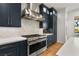 A well-lit kitchen features stainless steel appliances and sleek countertops providing a modern feel at 10717 Beringer Dr, Las Vegas, NV 89144