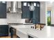 A well-appointed kitchen features stainless appliances, and an island with a sink and plenty of counter space at 10717 Beringer Dr, Las Vegas, NV 89144