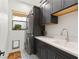 Charming laundry room featuring a stackable washer and dryer, decorative tile and ample counter space at 10717 Beringer Dr, Las Vegas, NV 89144
