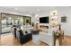 Spacious living room with comfortable seating, fireplace, built-in shelves and access to outdoor patio at 10717 Beringer Dr, Las Vegas, NV 89144