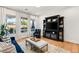 The bright living room features hardwood floors, a console, neutral colors and natural light at 10717 Beringer Dr, Las Vegas, NV 89144
