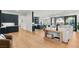 Open-concept living space with hardwood floors seamlessly connecting living and kitchen areas at 10717 Beringer Dr, Las Vegas, NV 89144