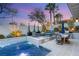 Inviting backyard pool area with lounge seating, dining area, and lush landscaping at 10717 Beringer Dr, Las Vegas, NV 89144