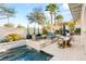 Inviting backyard pool area with lounge seating, dining area, and lush landscaping at 10717 Beringer Dr, Las Vegas, NV 89144