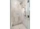 The shower is tiled with decorative marble in a hexagon pattern and features dual shower heads at 10717 Beringer Dr, Las Vegas, NV 89144