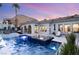 Beautiful swimming pool with integrated spa, lush landscaping, and an outdoor seating area at 10717 Beringer Dr, Las Vegas, NV 89144