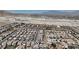 Community aerial view showcases dense housing near rugged desert landscape at 10729 Marathon Bell Ln, Las Vegas, NV 89129