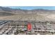 Expansive aerial view shows houses nestled against a scenic mountain backdrop at 10729 Marathon Bell Ln, Las Vegas, NV 89129