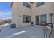 Spacious backyard with a patio, sliding glass doors, and serene mountain views in the background at 10729 Marathon Bell Ln, Las Vegas, NV 89129