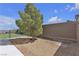 Landscaped backyard with gravel, a tree, and space for outdoor activities and relaxation at 10729 Marathon Bell Ln, Las Vegas, NV 89129