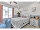 Comfortable bedroom with a large window and light-colored walls at 10729 Marathon Bell Ln, Las Vegas, NV 89129