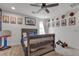 Comfortable bedroom with ceiling fan, carpeted floor, a gray bed, and playful decor at 10729 Marathon Bell Ln, Las Vegas, NV 89129