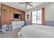 Stylish bedroom with modern decor, featuring a TV and a full-sized bed at 10729 Marathon Bell Ln, Las Vegas, NV 89129