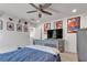 Inviting bedroom with ceiling fan, carpeted floor, a gray bed, tv and playful decor at 10729 Marathon Bell Ln, Las Vegas, NV 89129