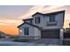 Charming two-story home with a tile roof, warm exterior lighting, and well-maintained landscaping, inviting curb appeal at 10729 Marathon Bell Ln, Las Vegas, NV 89129