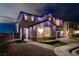 Inviting two-story home with manicured front lawn, walkway, and exterior lighting at 10729 Marathon Bell Ln, Las Vegas, NV 89129