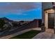 Well-lit front entrance features a dark door, pavers, and subtle landscaping at 10729 Marathon Bell Ln, Las Vegas, NV 89129