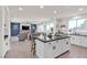 An open kitchen and living area showcasing a center island with seating and lots of light at 10729 Marathon Bell Ln, Las Vegas, NV 89129