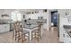 Bright, open kitchen featuring a large island with seating, sleek countertops, and modern stainless steel appliances at 10729 Marathon Bell Ln, Las Vegas, NV 89129