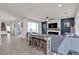 Open-concept living space with an electric fireplace, a ceiling fan and lots of natural light at 10729 Marathon Bell Ln, Las Vegas, NV 89129