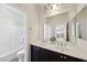 Bright bathroom with double sinks, a large mirror, and a shower-tub combo at 11707 Longworth Rd, Las Vegas, NV 89135
