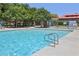 Community pool featuring lounge chairs and a fully fenced perimeter at 11707 Longworth Rd, Las Vegas, NV 89135