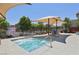 Community spa with a shaded patio area, complete with seating and a secure fence at 11707 Longworth Rd, Las Vegas, NV 89135