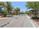 Community entrance featuring a gated entry, mature landscaping, and paved roads at 11707 Longworth Rd, Las Vegas, NV 89135