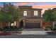 Two-story home with landscaped front yard and a two-car garage against a beautiful sunset sky at 11707 Longworth Rd, Las Vegas, NV 89135