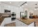 Well-lit kitchen boasts white cabinetry, stainless steel appliances, granite countertops, and a center island at 11707 Longworth Rd, Las Vegas, NV 89135