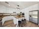 Modern kitchen with white cabinets, granite countertops, and a stainless steel refrigerator and appliances at 11707 Longworth Rd, Las Vegas, NV 89135