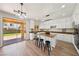 Spacious kitchen features white cabinets, stainless steel appliances, granite countertops, and backyard access at 11707 Longworth Rd, Las Vegas, NV 89135