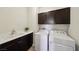 Functional laundry room includes modern washer and dryer, with ample cabinet space at 11707 Longworth Rd, Las Vegas, NV 89135