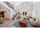 Bright living room with high ceilings, iron stair railing, and comfortable seating, with a decorative rug at 11707 Longworth Rd, Las Vegas, NV 89135