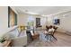 Open-concept living area with comfortable gray sofa, dining area, and decorative art at 11707 Longworth Rd, Las Vegas, NV 89135