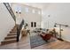 Spacious living room showcasing the staircase, tall ceilings, and large windows for lots of natural light at 11707 Longworth Rd, Las Vegas, NV 89135
