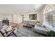 Bright living room features a comfortable gray sectional sofa, decorative rug, and art at 11707 Longworth Rd, Las Vegas, NV 89135
