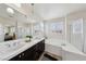Spacious main bathroom with double sinks, a soaking tub, and a separate glass shower at 11707 Longworth Rd, Las Vegas, NV 89135