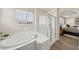 Bright bathroom featuring a soaking tub and glass shower enclosure for a spa-like experience at 11707 Longworth Rd, Las Vegas, NV 89135
