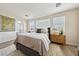 Bright main bedroom with a comfortable bed, warm textiles, and a view of the bathroom at 11707 Longworth Rd, Las Vegas, NV 89135