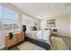 Well-lit main bedroom with a comfortable bed, soft rug, and a view of the neighborhood at 11707 Longworth Rd, Las Vegas, NV 89135