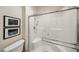 Modern bathroom showcases an updated shower with glass doors, tiled walls, and seat at 11707 Longworth Rd, Las Vegas, NV 89135